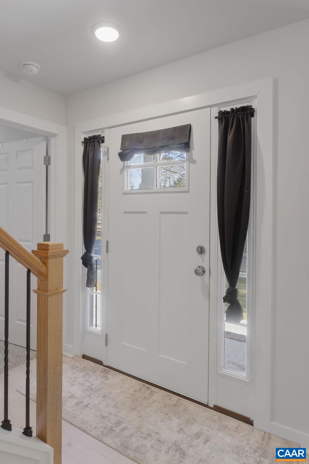 7440 Louisa Road Gordonsville, VA 22942 - Photo 7 of 40 a view of a hallway with paintings on the wall