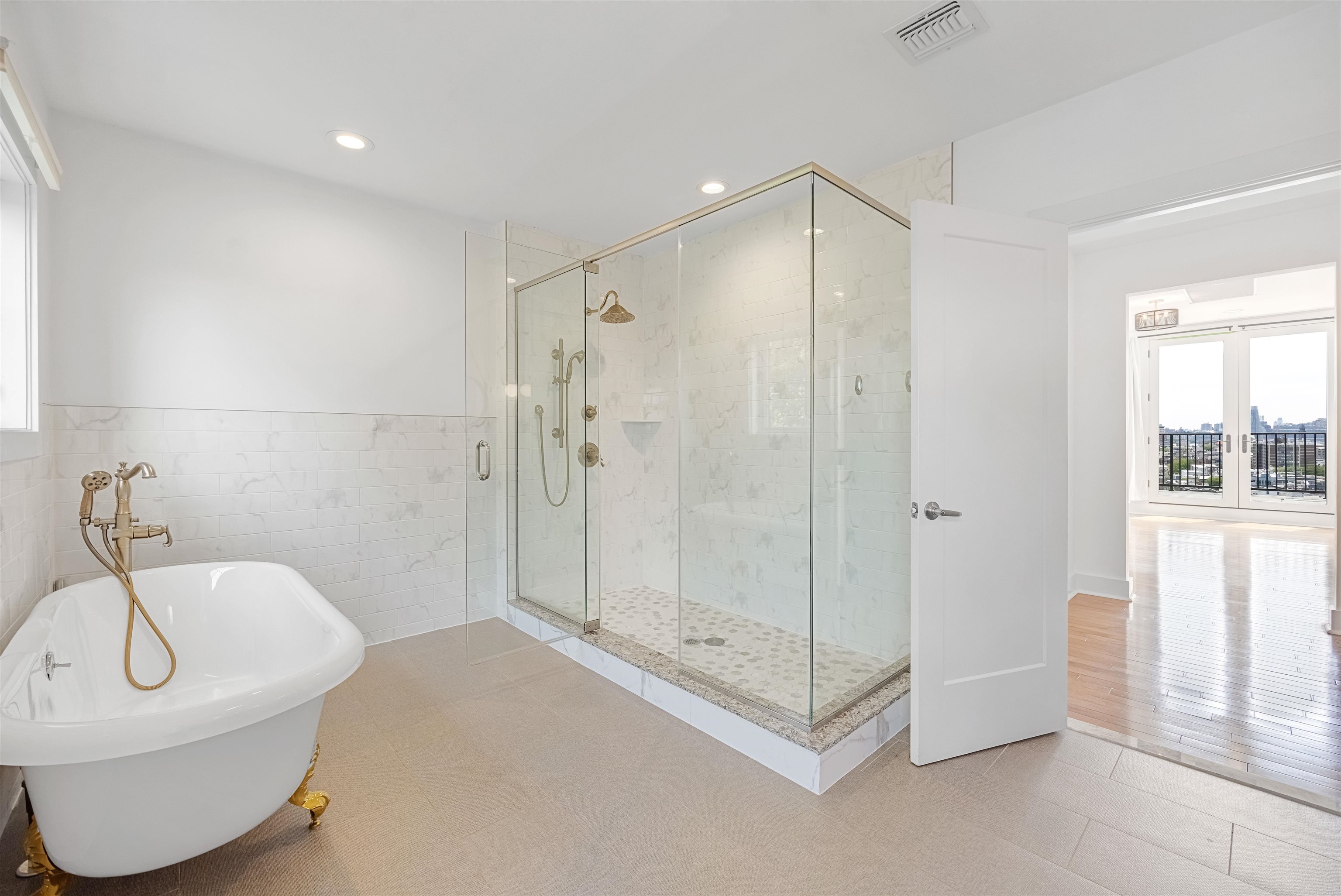 107 Mountain Road Jersey City, NJ 07307 - Photo 20 of 41 a bathroom with a tub a window and a glass door shower