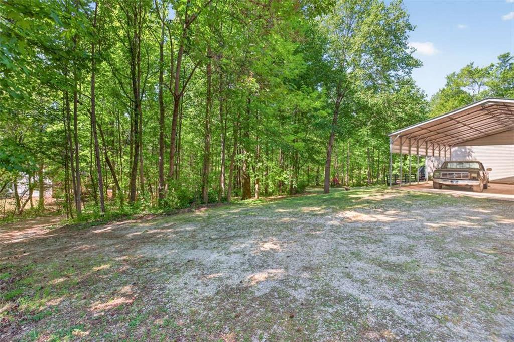 386 Ridgewood Drive Pendergrass, GA 30567 - Photo 36 of 50 a view of a yard with large trees