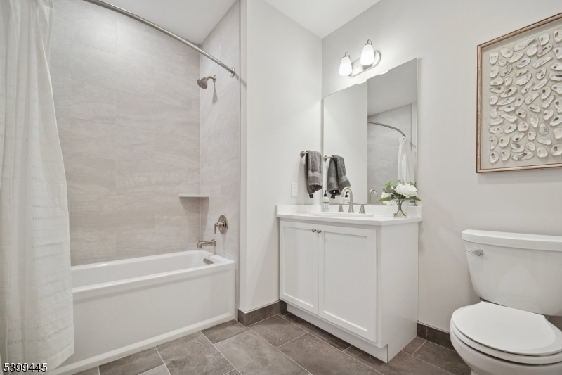 246 Main Street, Unit 304 Chatham, NJ 07928 - Photo 13 of 31 a bathroom with a sink a toilet and shower