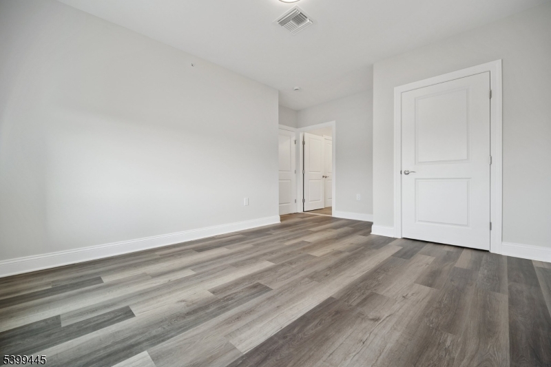 246 Main Street, Unit 304 Chatham, NJ 07928 - Photo 15 of 31 a view of an empty room and wooden floor