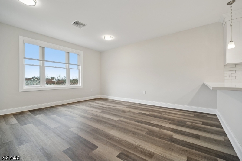 246 Main Street, Unit 304 Chatham, NJ 07928 - Photo 10 of 31 wooden floor in an empty room with a window