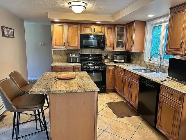 a kitchen with a stove a sink and a microwave