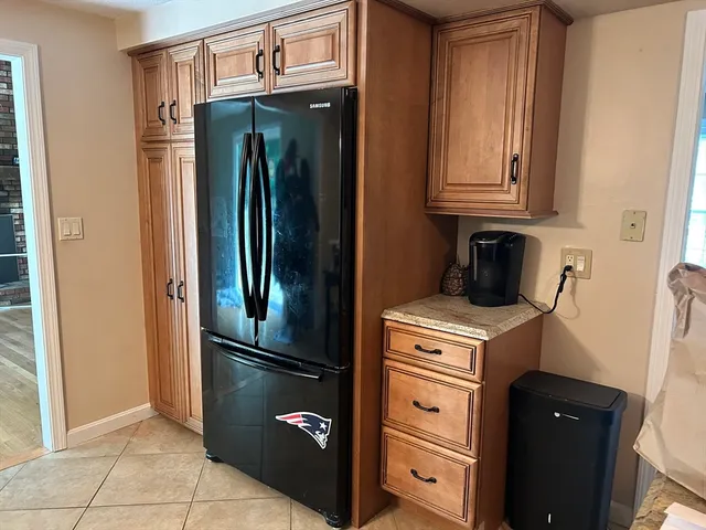 a kitchen with a refrigerator and cabinets