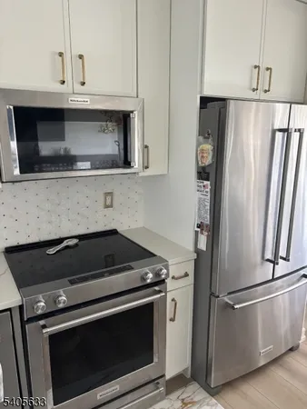 a kitchen with appliances and cabinets