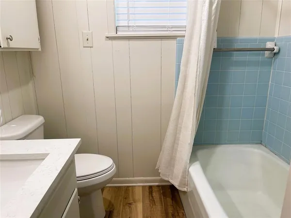 a bathroom with a toilet and shower