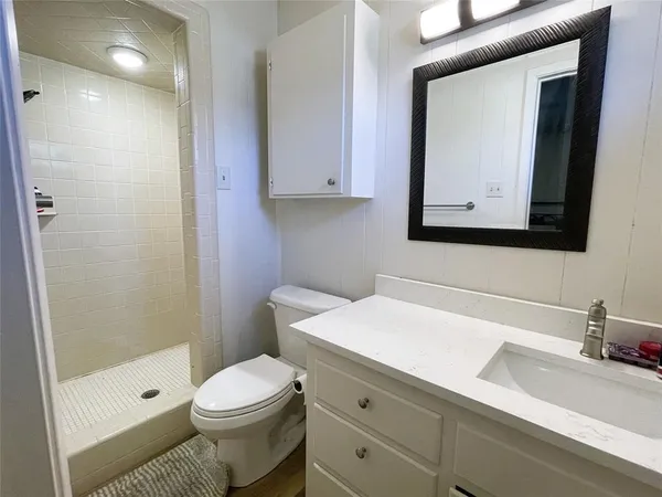 a bathroom with a toilet a sink and a mirror