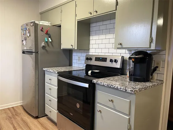 a kitchen with a stove and a refrigerator