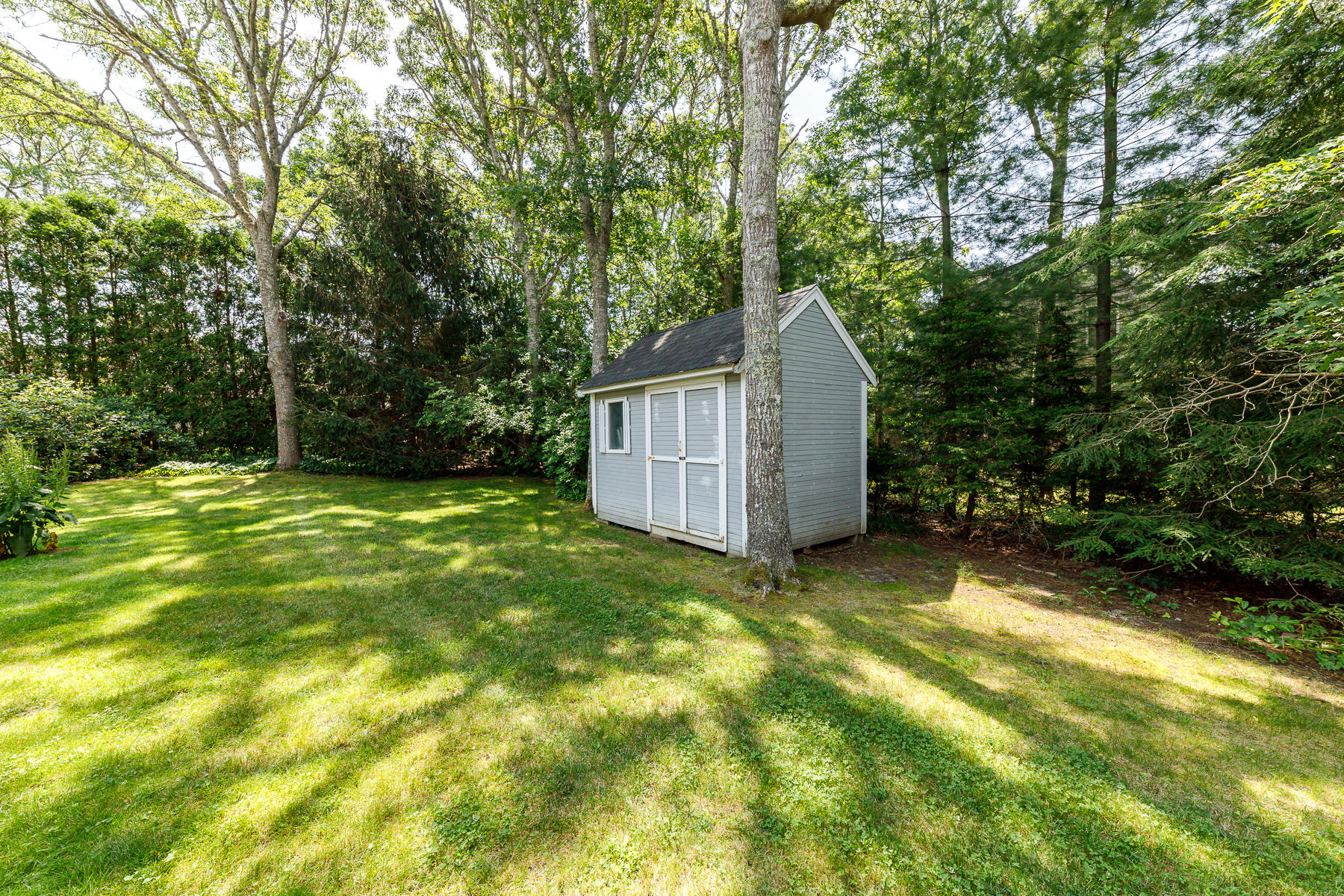3 Rivers End Road East Falmouth, MA 02536 - Photo 4 of 38 a view of a backyard with small cabin