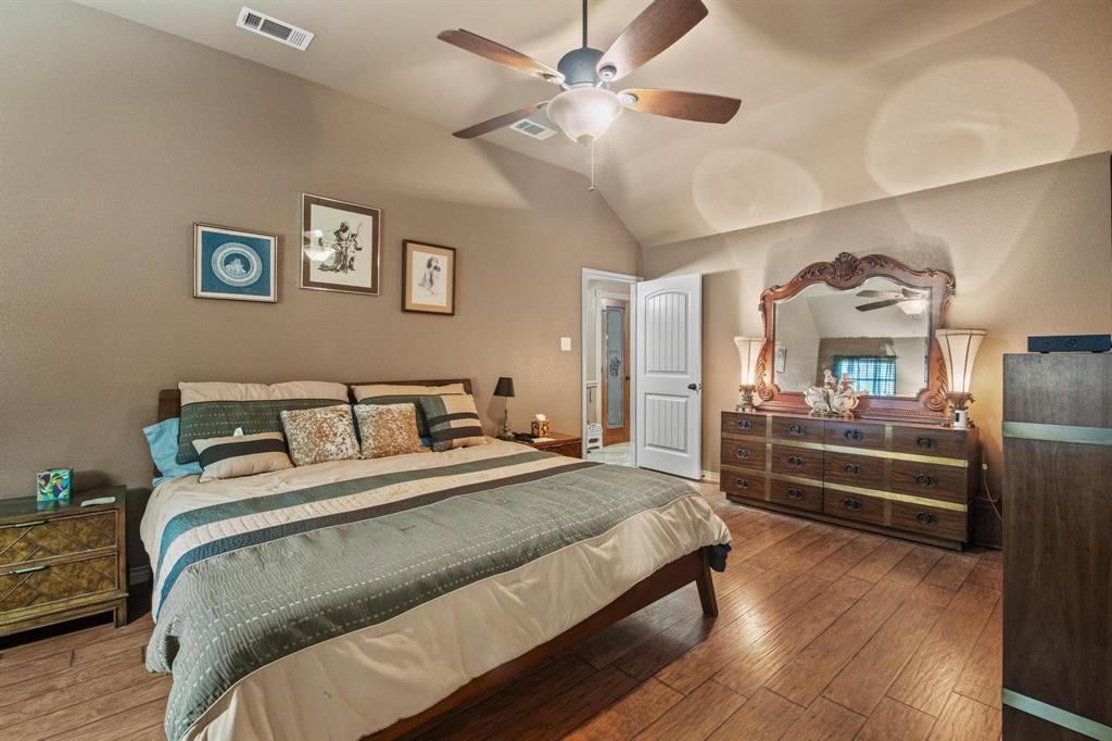 112 Knight Court Springtown, TX 76082 - Photo 15 of 26 Vaulted ceiling, wood-finish flooring, ceiling fan with integrated lighting, paneled interior door, recessed lighting