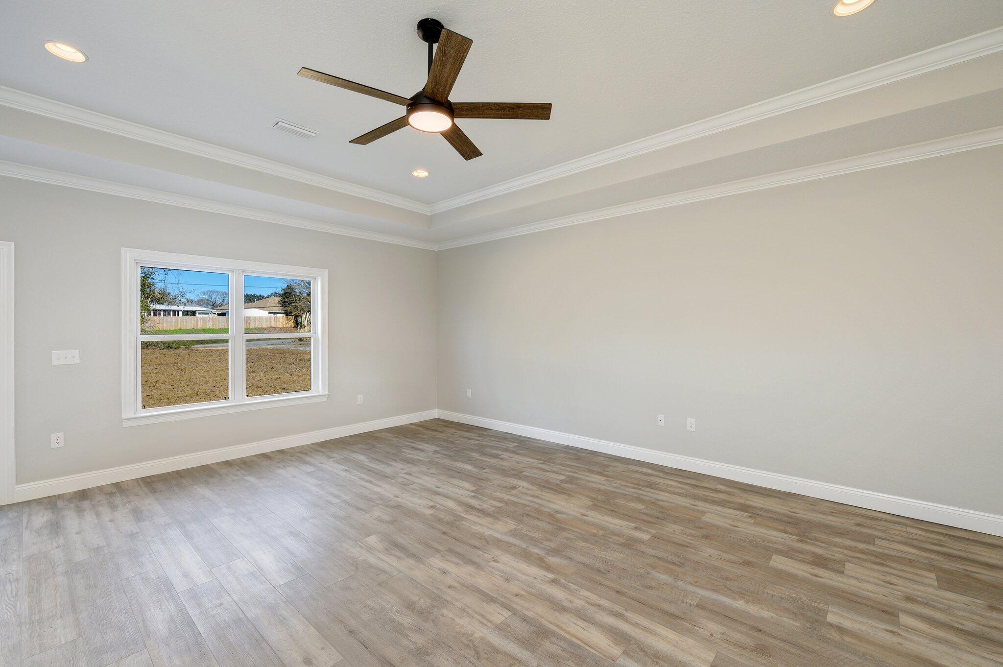 107 Winchester Way Crestview, FL 32539 - Photo 11 of 46 a view of a livingroom with a ceiling fan and wooden floor
