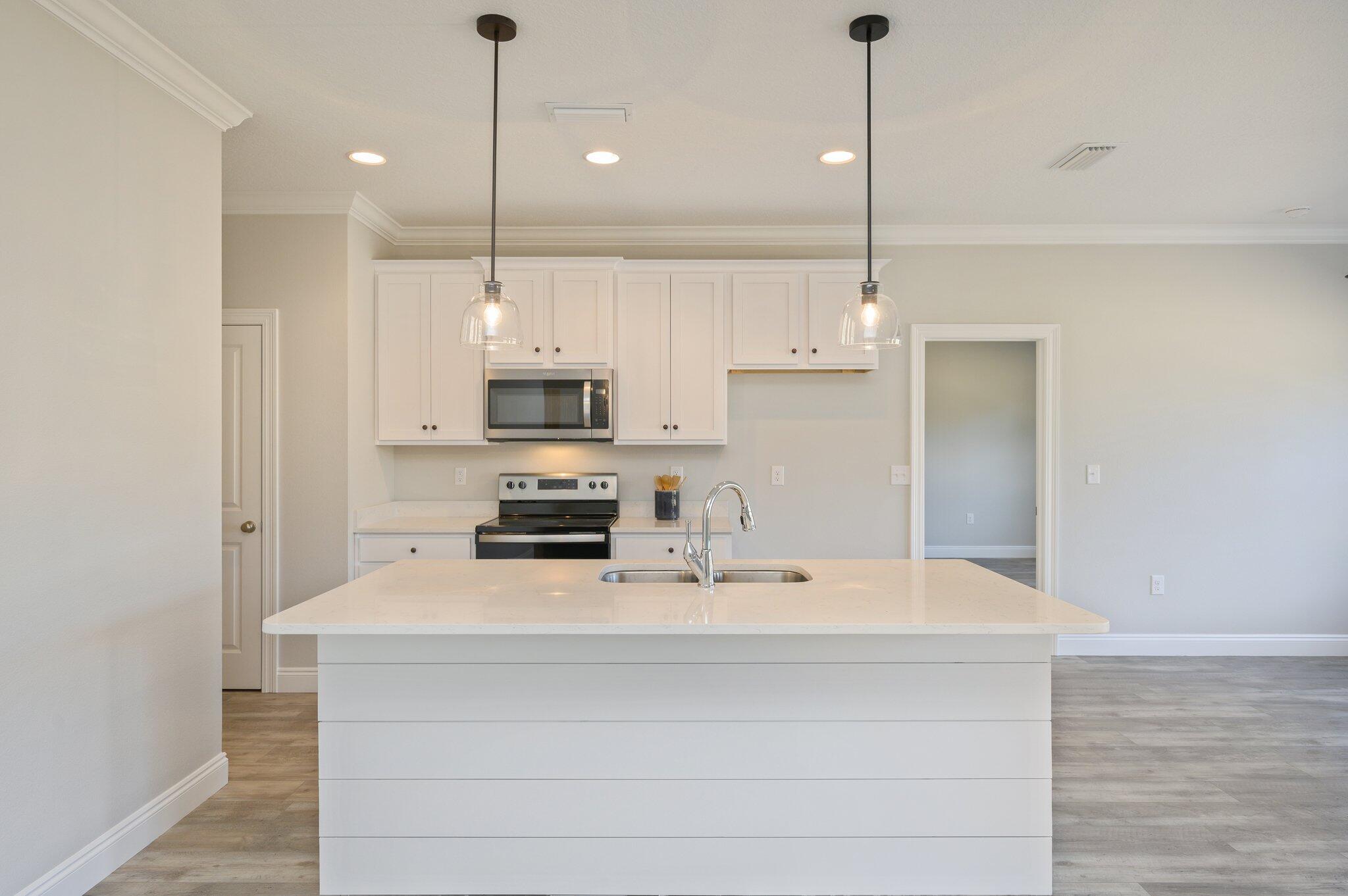 107 Winchester Way Crestview, FL 32539 - Photo 17 of 46 a kitchen with stainless steel appliances a stove sink and microwave