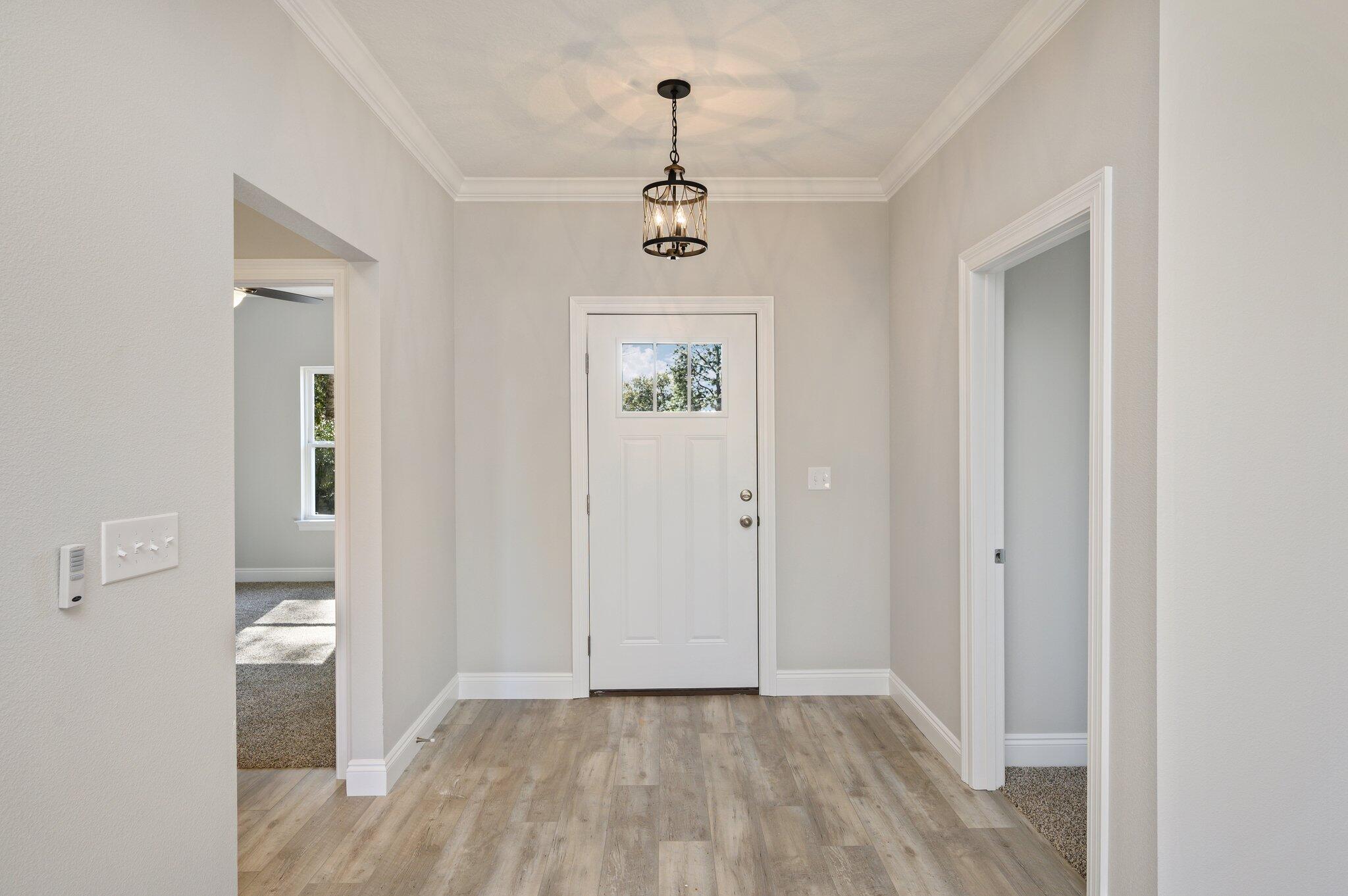 107 Winchester Way Crestview, FL 32539 - Photo 39 of 46 a view of a hallway with wooden floor and a bathroom