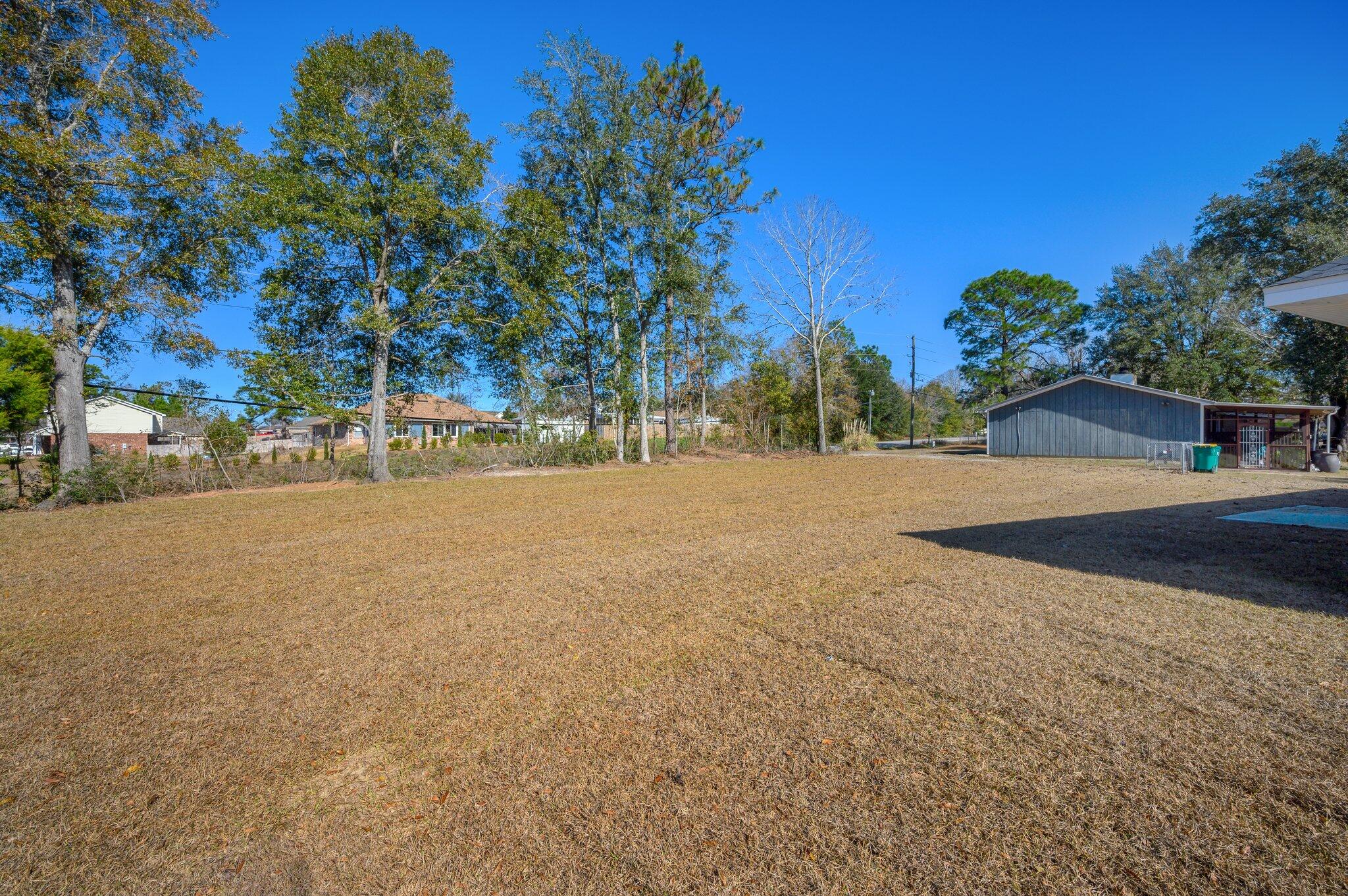 107 Winchester Way Crestview, FL 32539 - Photo 44 of 46 a backyard of a house with lots of green space