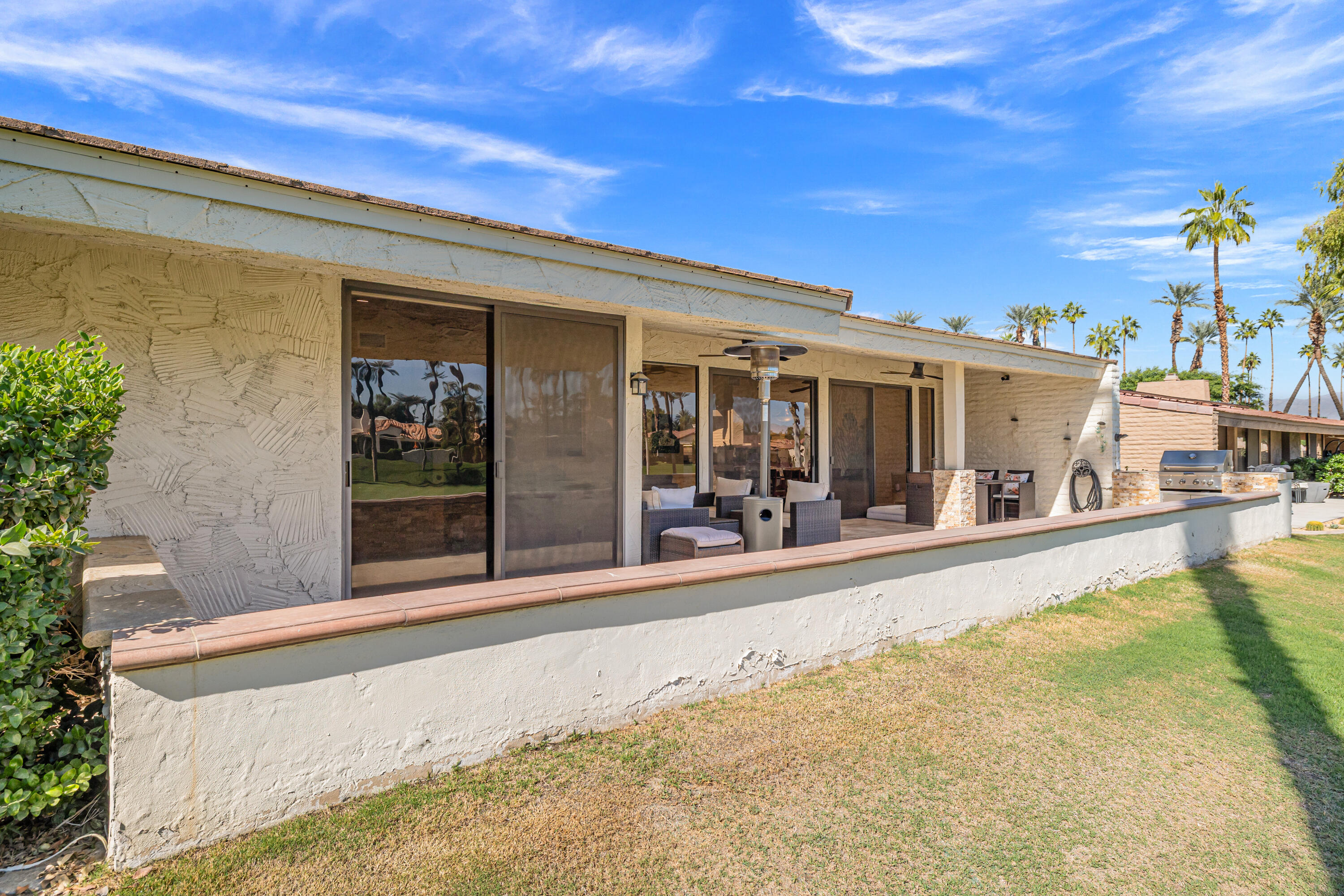 44828 Oro Grande Circle Indian Wells, CA 92210 - Photo 16 of 59 a view of a house with a swimming pool