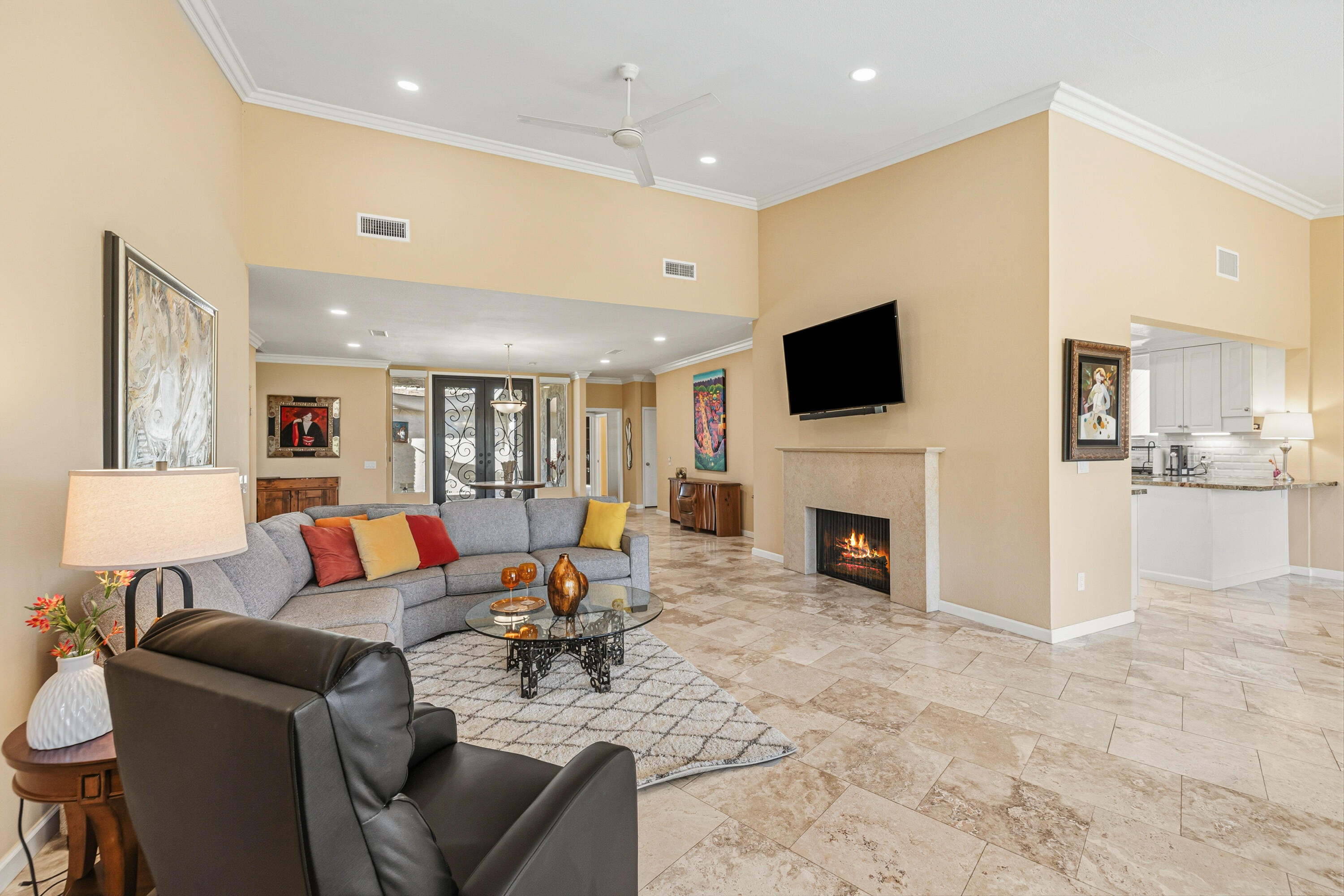 44828 Oro Grande Circle Indian Wells, CA 92210 - Photo 28 of 59 a living room with furniture a fireplace and a flat screen tv