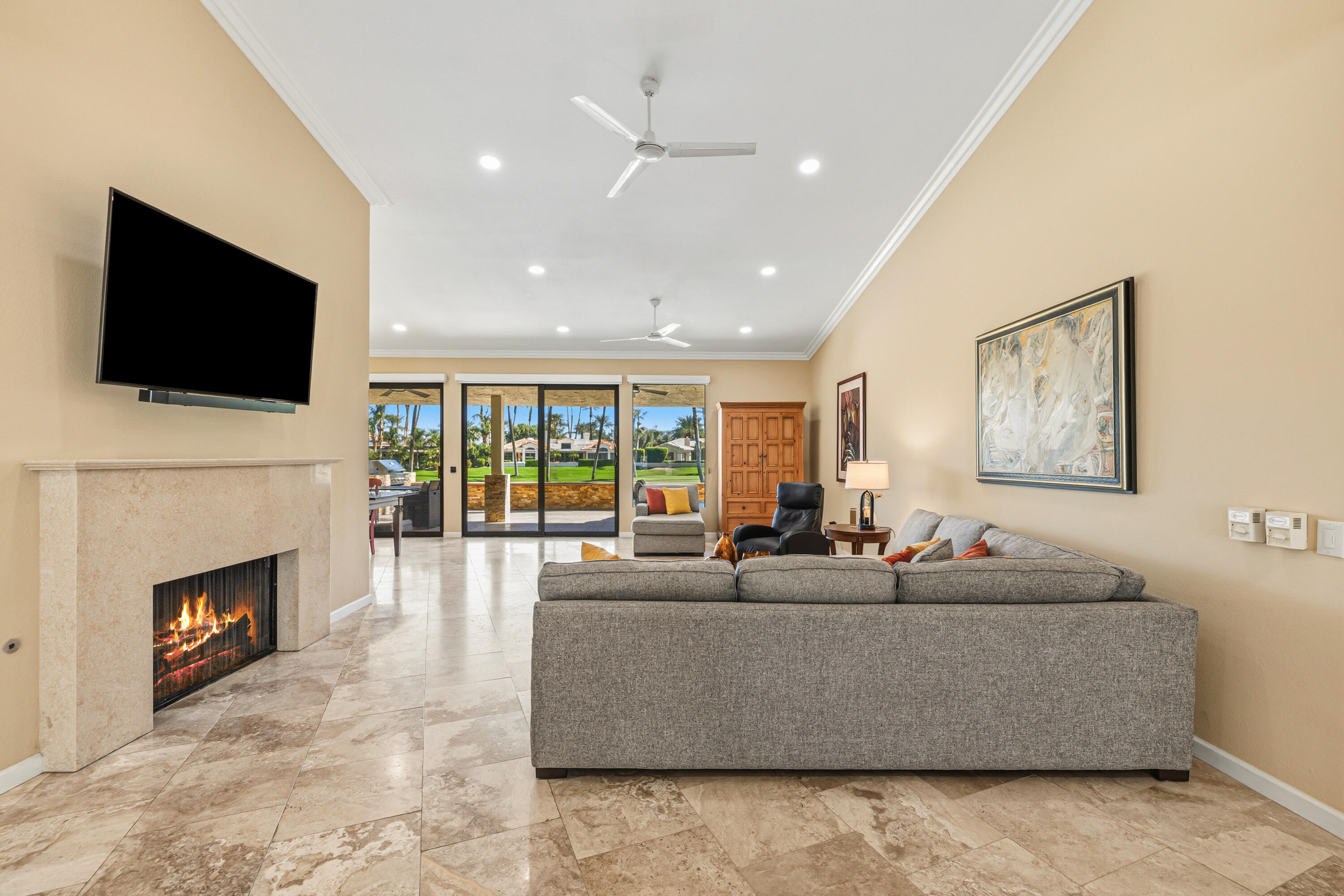 44828 Oro Grande Circle Indian Wells, CA 92210 - Photo 30 of 59 a living room with fireplace furniture and a flat screen tv