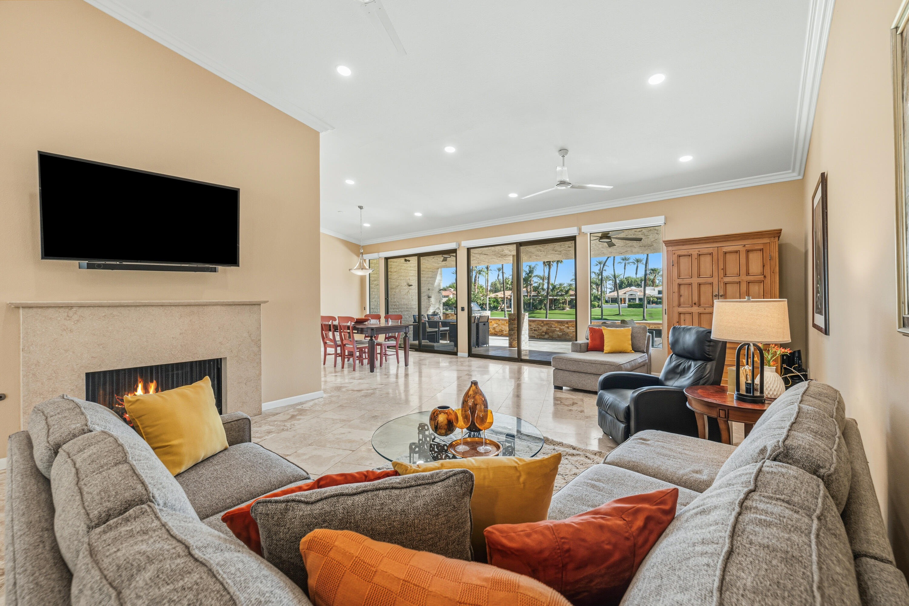 44828 Oro Grande Circle Indian Wells, CA 92210 - Photo 31 of 59 a living room with furniture a flat screen tv and a fireplace