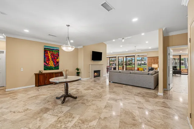 a living room with a bed furniture and a flat screen tv