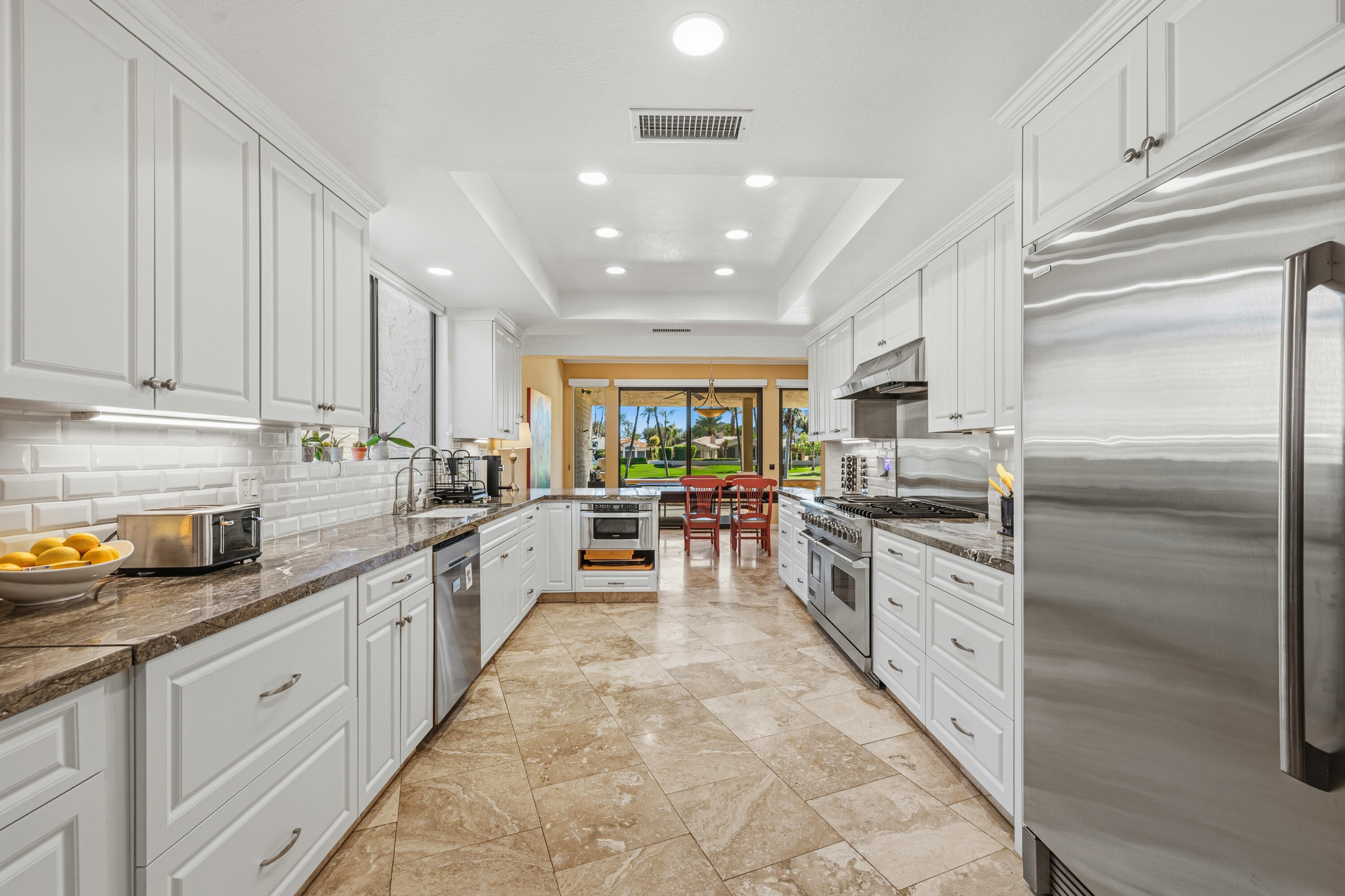 44828 Oro Grande Circle Indian Wells, CA 92210 - Photo 36 of 59 a large kitchen with stainless steel appliances lots of counter space sink and cabinets