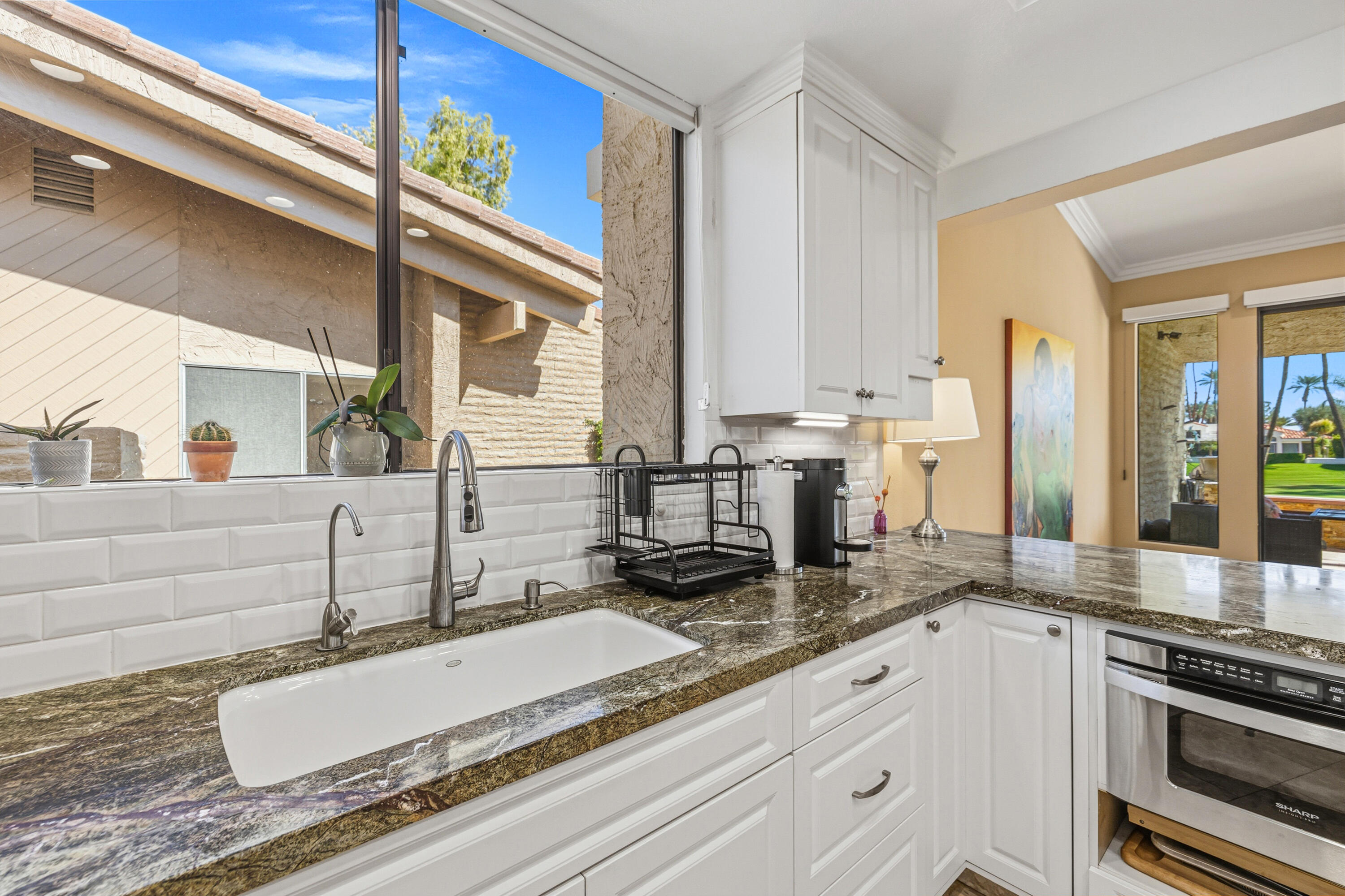 44828 Oro Grande Circle Indian Wells, CA 92210 - Photo 38 of 59 a bathroom with a granite countertop sink and a mirror