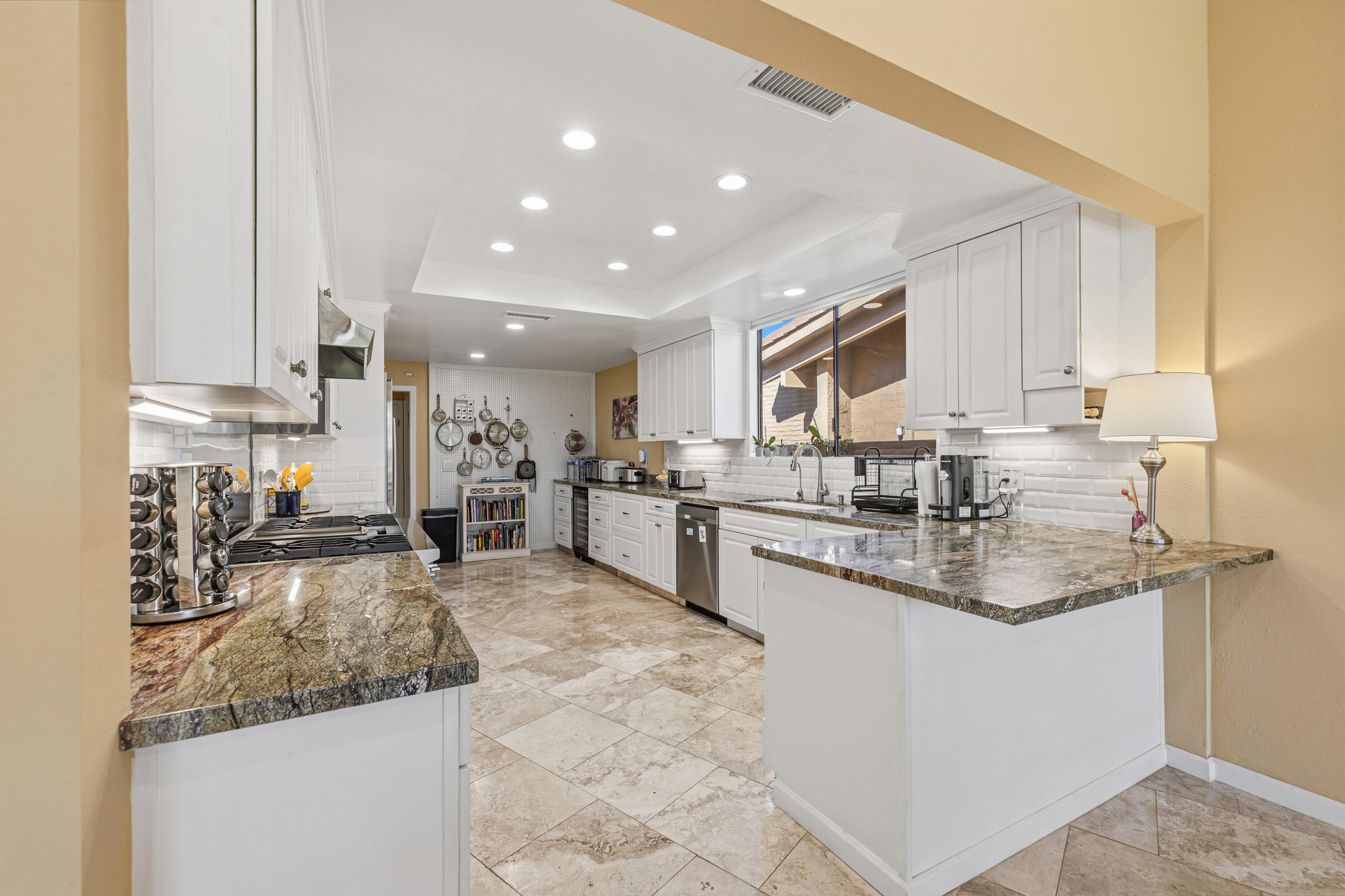 44828 Oro Grande Circle Indian Wells, CA 92210 - Photo 39 of 59 a kitchen with stainless steel appliances granite countertop a sink stove and cabinets