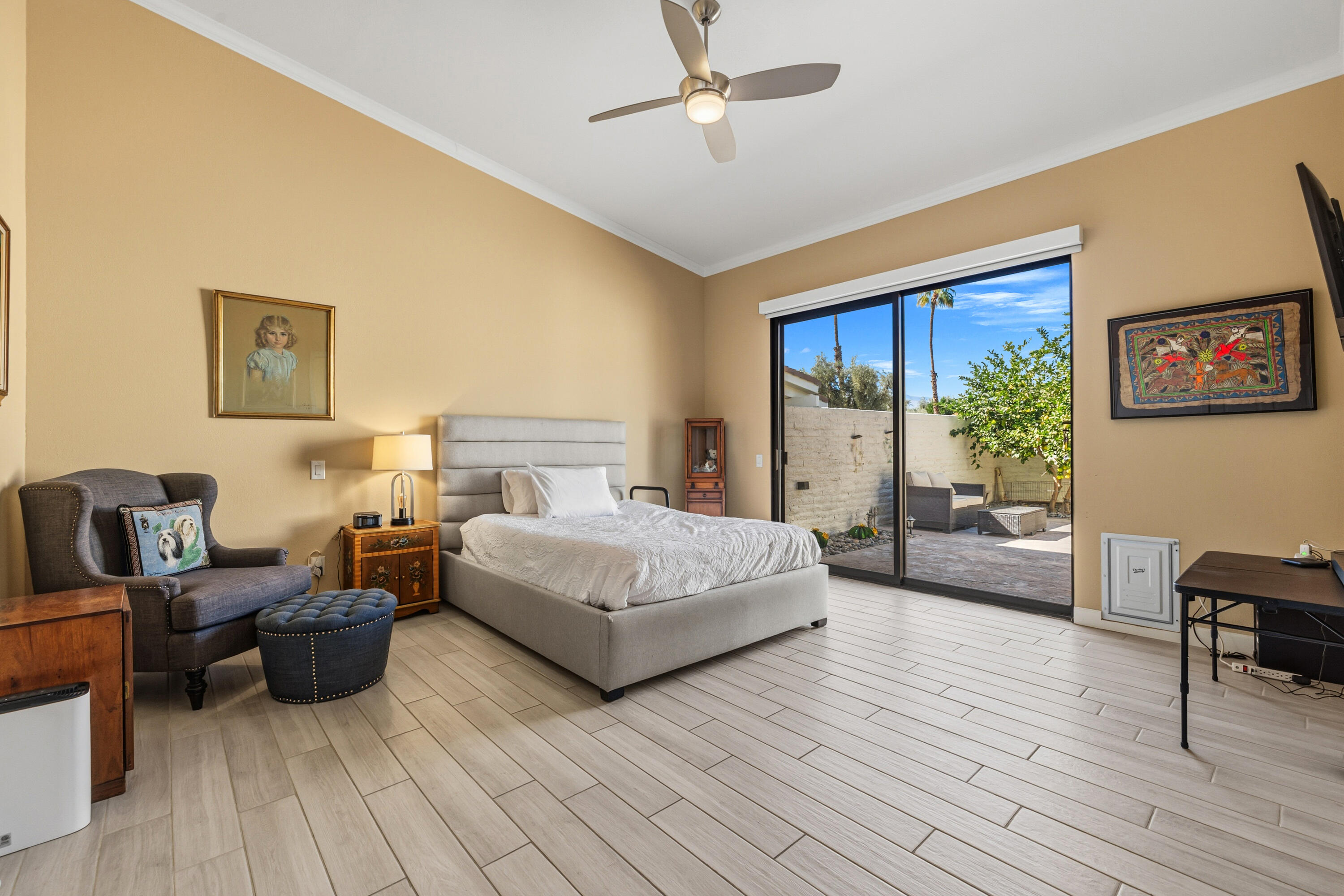 44828 Oro Grande Circle Indian Wells, CA 92210 - Photo 57 of 59 a spacious bedroom with a bed a table and painting on the wall