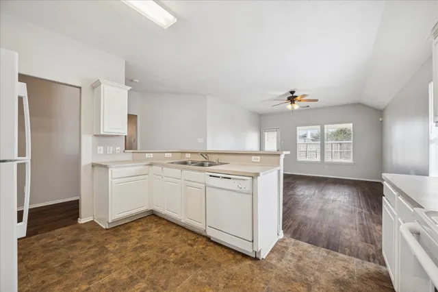 a kitchen with a sink cabinets and appliances