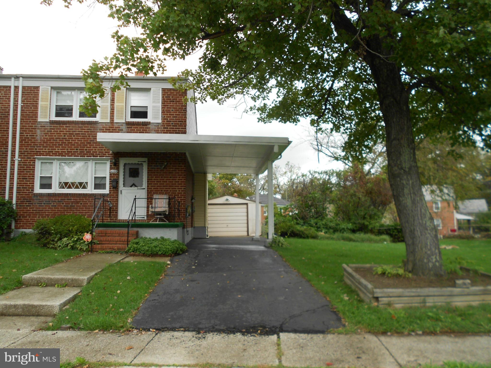 6235 Robin Hill Road Baltimore, MD 21207 - Photo 1 of 30 a front view of a house with garden