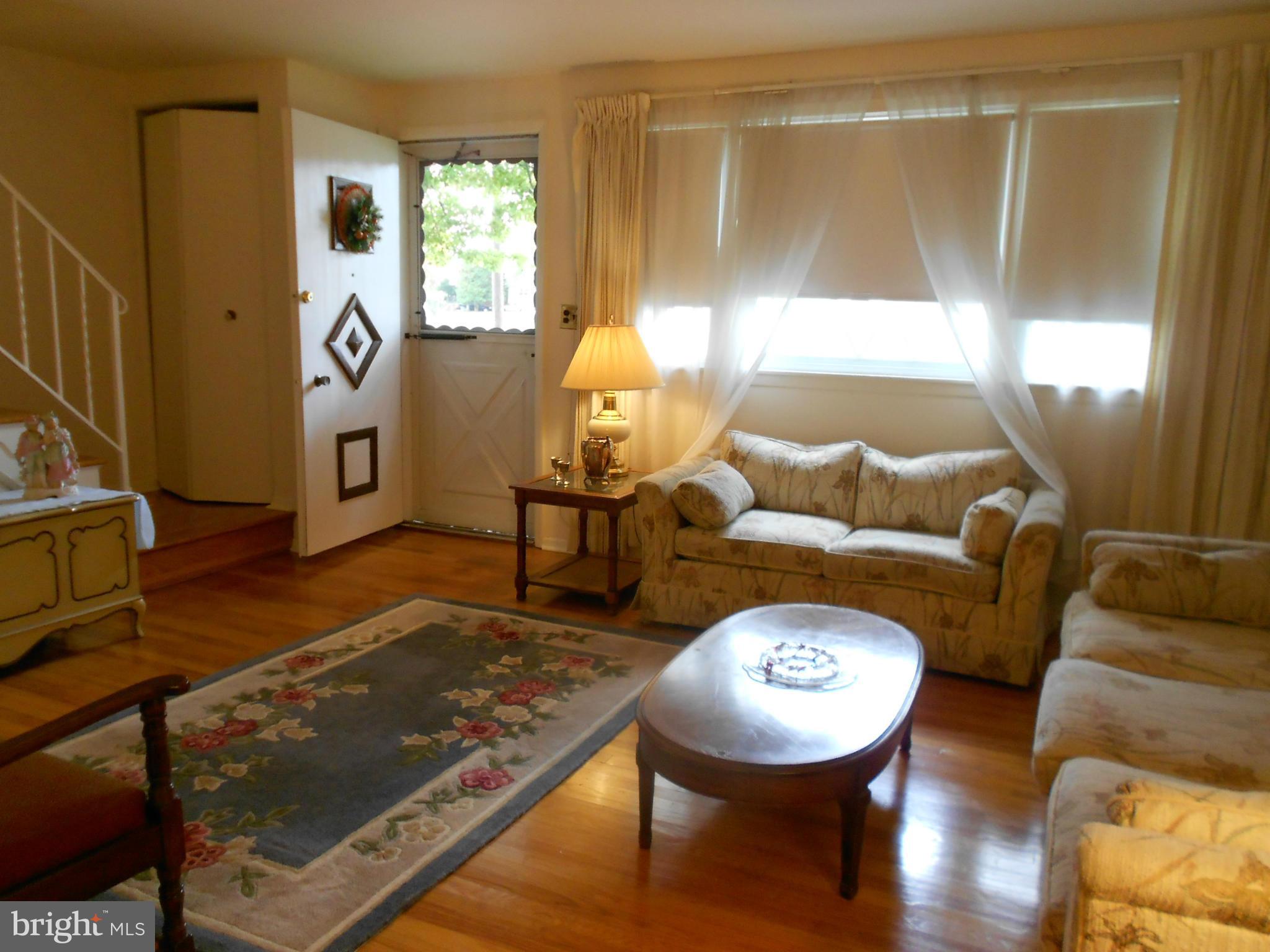 6235 Robin Hill Road Baltimore, MD 21207 - Photo 11 of 30 a living room with furniture and a large window