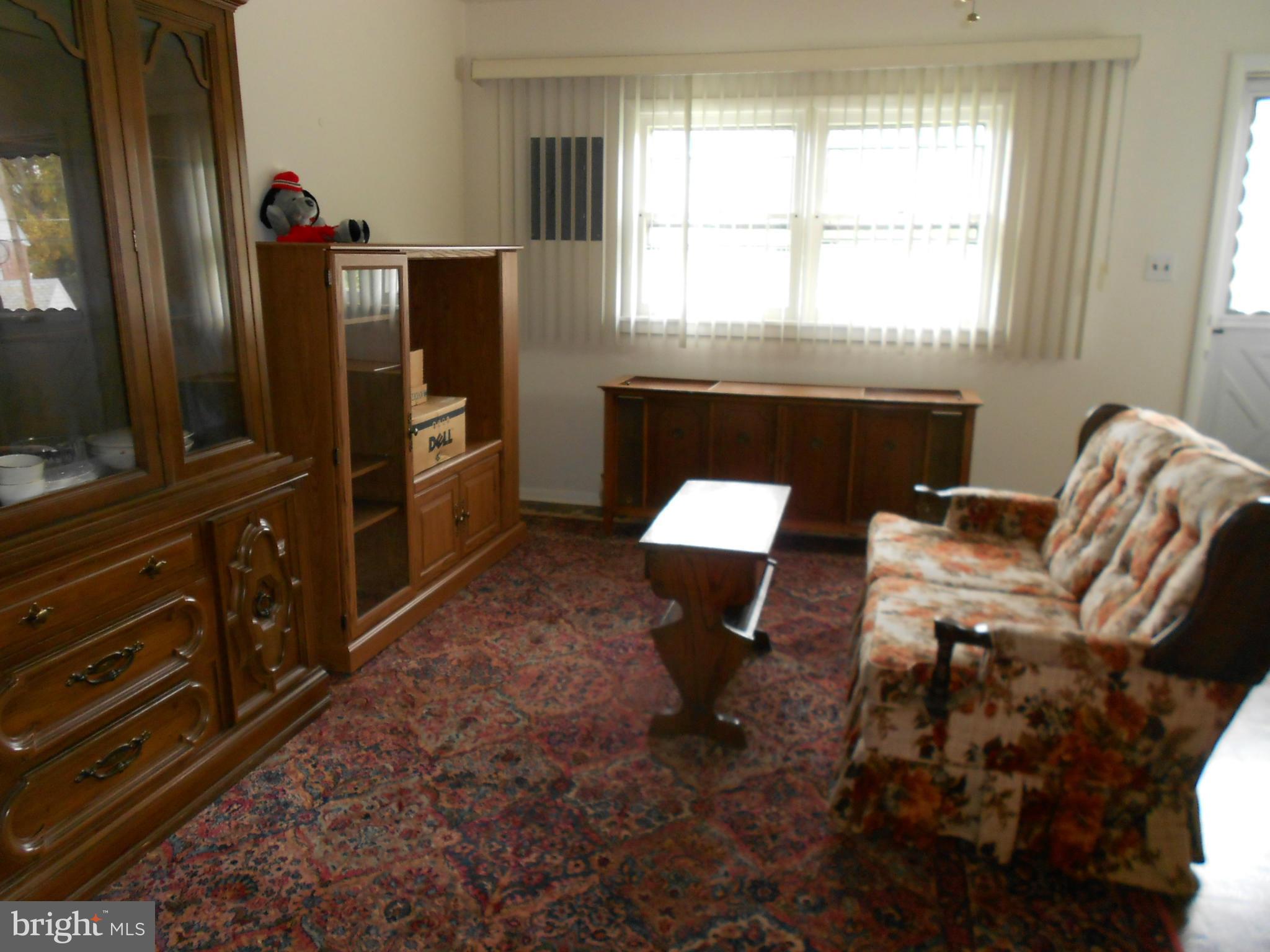6235 Robin Hill Road Baltimore, MD 21207 - Photo 12 of 30 a living room with furniture a flat screen tv and a window