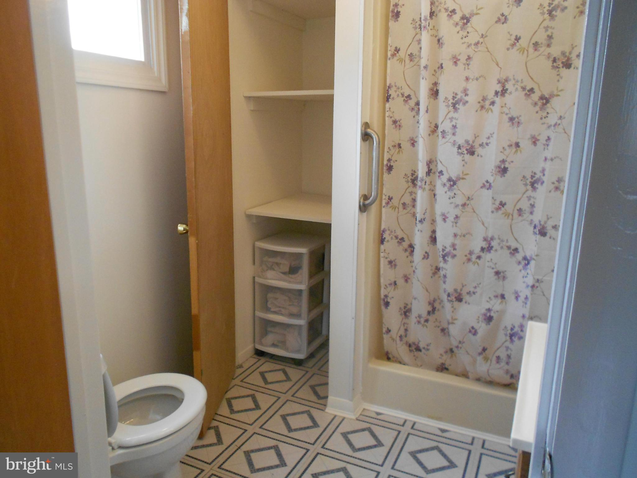 6235 Robin Hill Road Baltimore, MD 21207 - Photo 14 of 30 a bathroom with a toilet and a shower