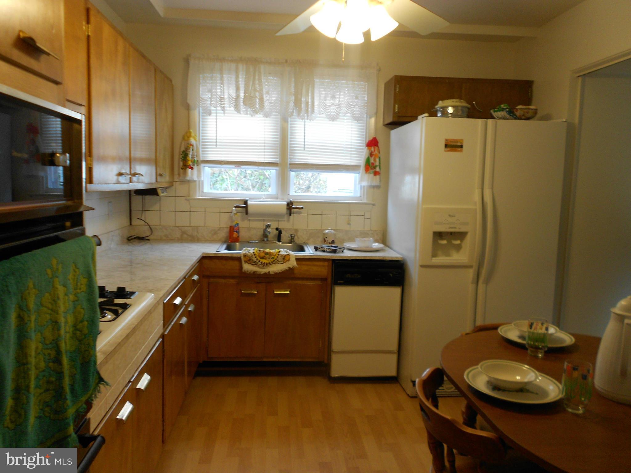 6235 Robin Hill Road Baltimore, MD 21207 - Photo 17 of 30 a kitchen with sink a refrigerator and a stove