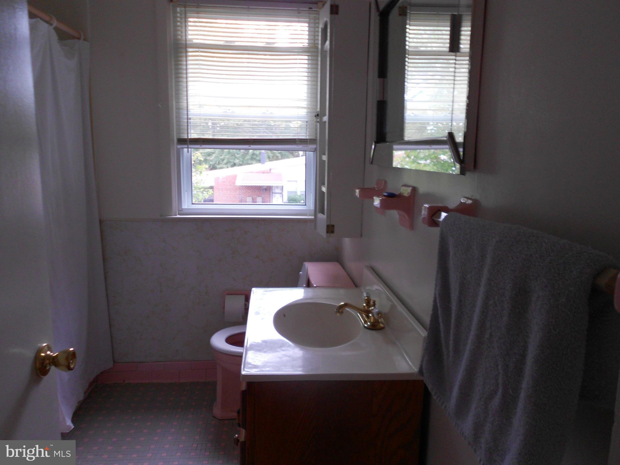 6235 Robin Hill Road Baltimore, MD 21207 - Photo 20 of 30 a bathroom with a sink a toilet and a mirror