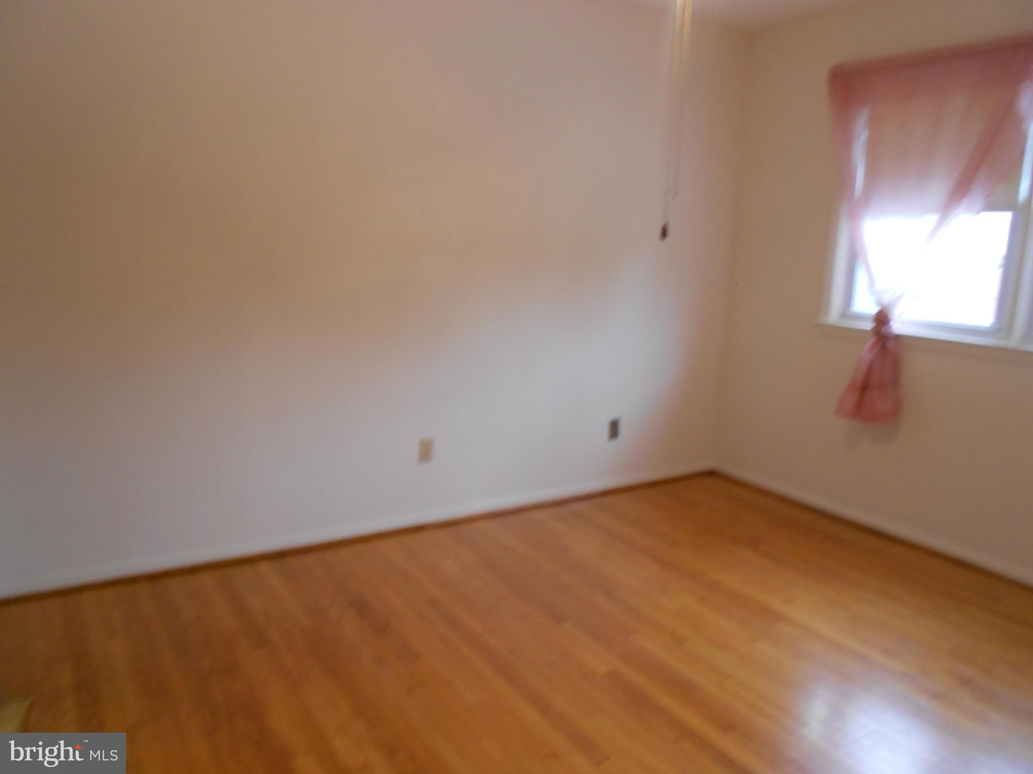 6235 Robin Hill Road Baltimore, MD 21207 - Photo 22 of 30 a view of an empty room and window