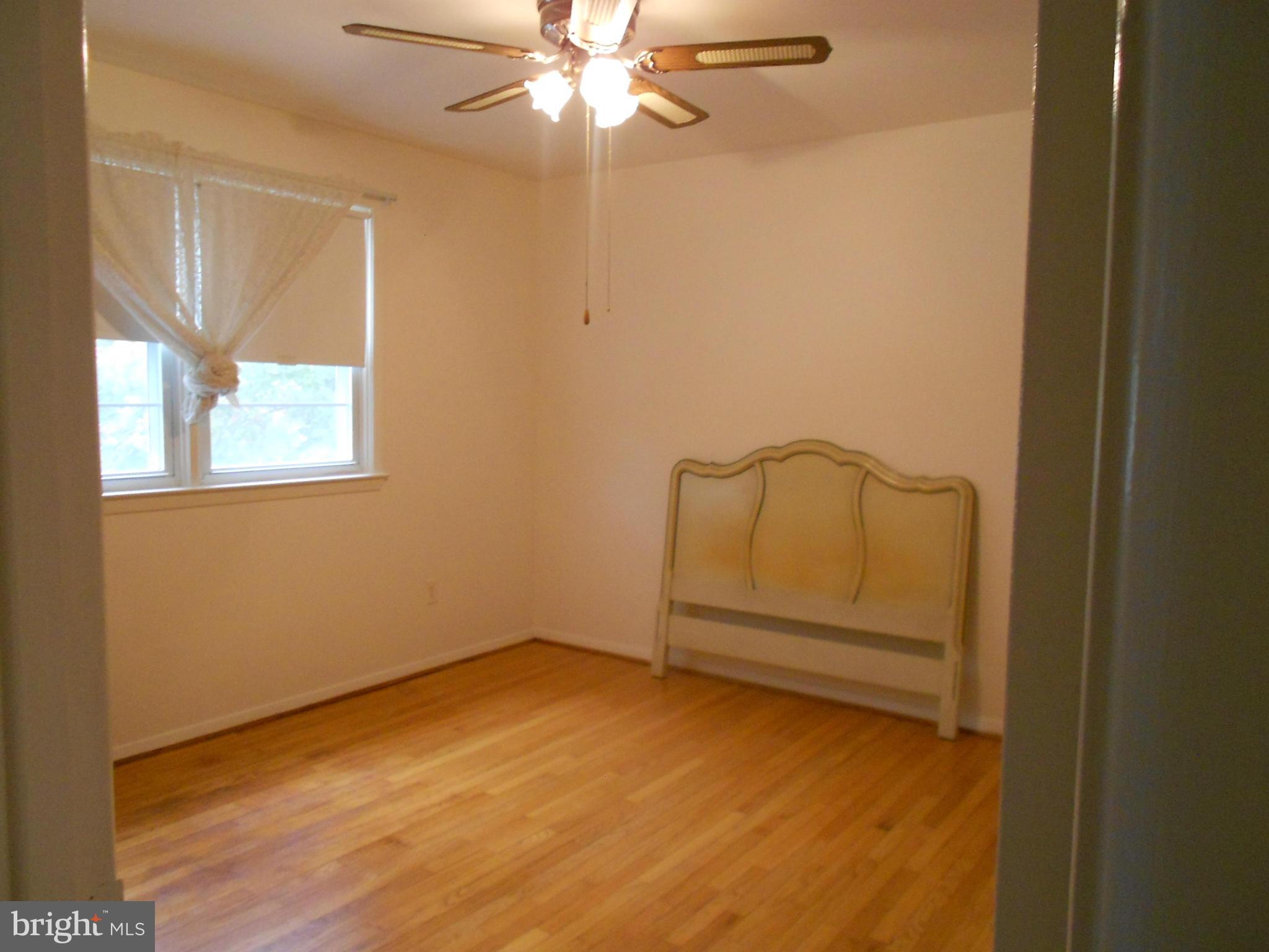 6235 Robin Hill Road Baltimore, MD 21207 - Photo 23 of 30 an empty room with windows and fan