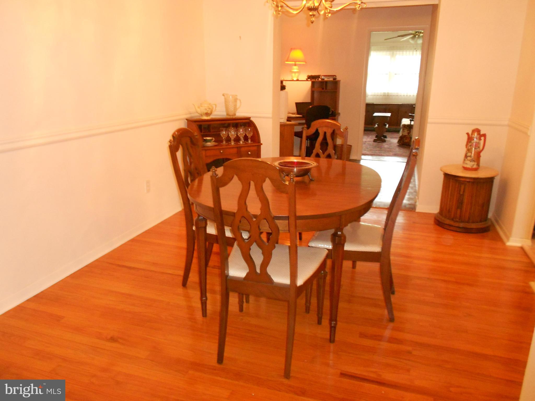 6235 Robin Hill Road Baltimore, MD 21207 - Photo 8 of 30 a dining room with furniture and wooden floor