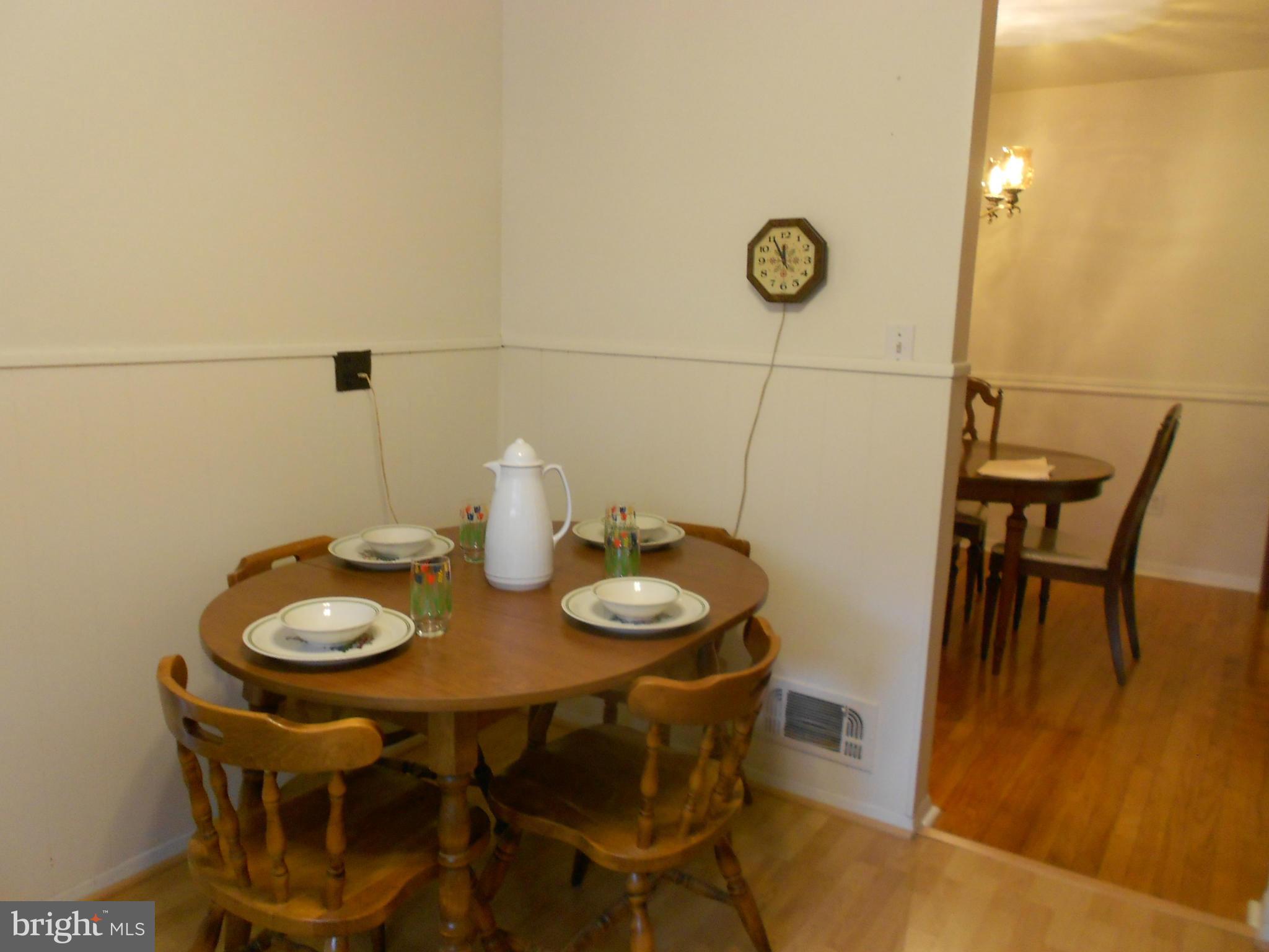 6235 Robin Hill Road Baltimore, MD 21207 - Photo 10 of 30 a dining room with furniture and wooden floor