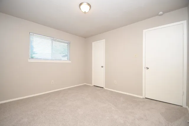 a bedroom with a bed and a lamp on table
