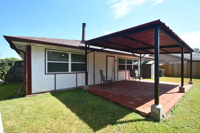 a kitchen with granite countertop a sink a counter space appliances and cabinets
