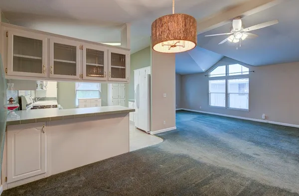 a kitchen with a sink a stove and cabinets