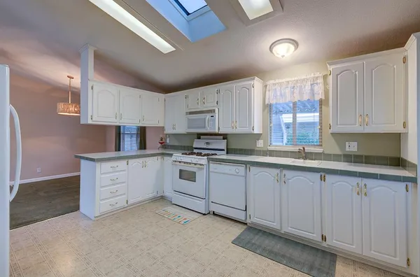 a kitchen with cabinets and a stove top oven