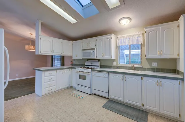 a kitchen with cabinets and a stove top oven
