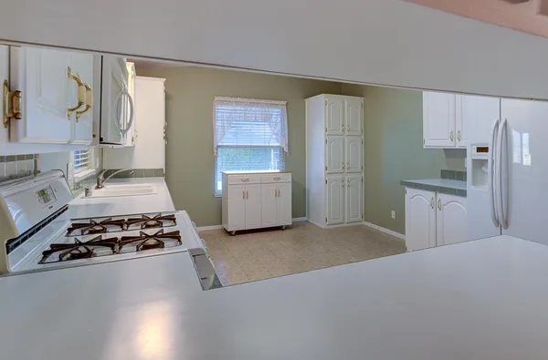 an empty room with a ceiling fan and a window