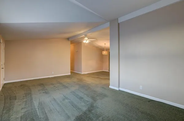 an empty room with a empty space and windows