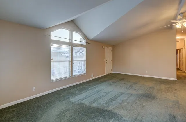 a view of kitchen and kitchen with granite countertop cabinets