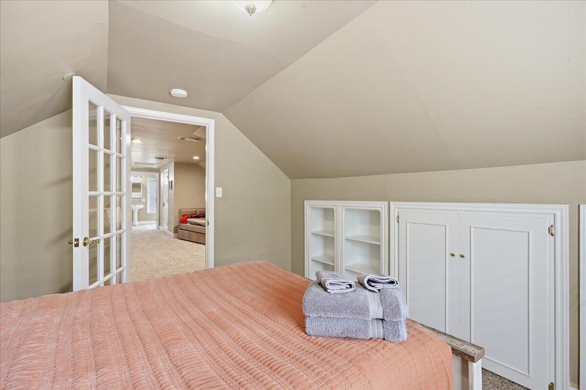 2702 20th Street Lubbock, TX 79410 - Photo 24 of 34 a bedroom with a bed and a large mirror