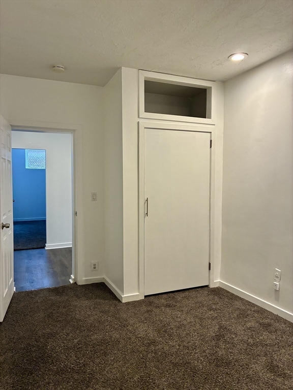 382 Commonwealth Avenue, Unit B1 Boston, MA 02215 - Photo 11 of 22 an empty room with wooden door