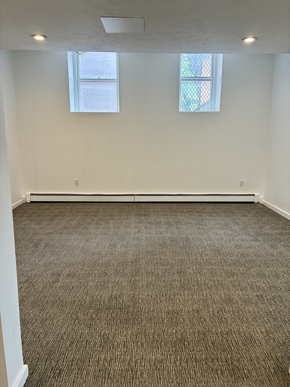 382 Commonwealth Avenue, Unit B1 Boston, MA 02215 - Photo 14 of 22 an empty room with a workbench