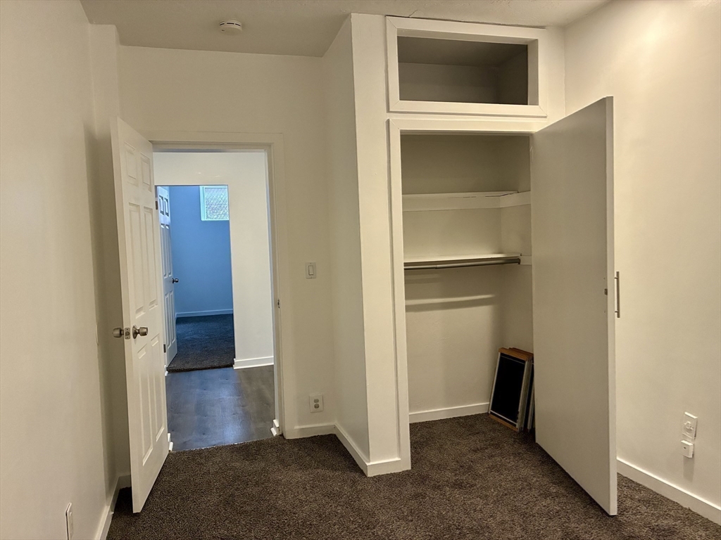 382 Commonwealth Avenue, Unit B1 Boston, MA 02215 - Photo 10 of 22 a view of an empty room with closet and wooden door